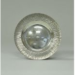 A mid 20th Century silver dish, the flared rim of bark texture (by Gerald Benney, London 1970),