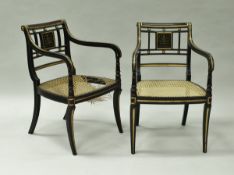 A pair of ebonised and gilt decorated bar back elbow chairs in the Regency taste,