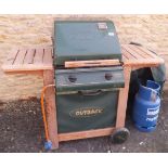 An Outback Trooper gas barbecue and canvas cover