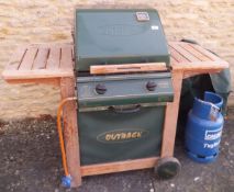 An Outback Trooper gas barbecue and canvas cover