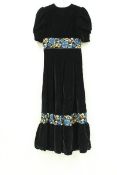 A collection of clothing comprising a 1970s velvet maxi dress, two 1980s black dresses,