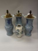 A set of three Chinese vases as table lamps of flared baluster form with blue and white floral