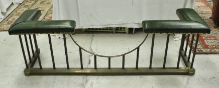 An early 20th Century brass club fender with studded green leather upholstered end seats on plain