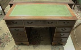 A modern yew wood veneered double pedestal desk and two tooled and gilded leather topped filing