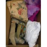 A box containing assorted scrap material, needlework,