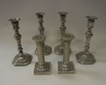 A set of four modern white metal candlesticks in the 18th Century manner, 24.