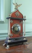 A late 19th Century Continental Empire style watch stand with fob watch and a miniature brass