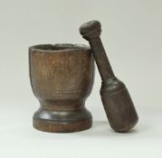 A 19th Century treenware mortar and pestle 18 cm high by 14.