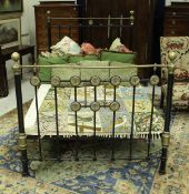 A late Victorian black painted iron and brass three quarter bedstead with reeded medallion applied