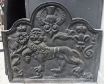 A cast iron fire back in the 17th Century manner decorated in high relief with a lion passant