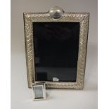A modern silver photograph frame with embossed decoration (bears maker's mark "RH",