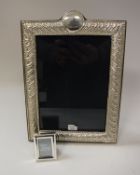 A modern silver photograph frame with embossed decoration (bears maker's mark "RH",