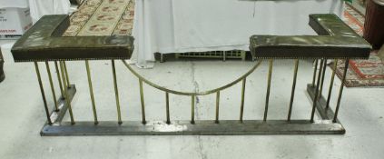 An early 20th Century brass club fender with studded brown leather upholstered end seats on plain