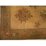 An Aubusson style rug the central panel set with floral sprays on a neutral ground within a stepped