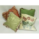 Three boxes of assorted scatter cushions in pink and green hues