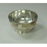 A mid 20th Century silver bowl of plain form raised on circular stepped foot (by Garrard & Co.