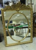 A carved giltwood and gesso framed wall mirror in the George III taste the foliate and dragon scale