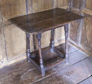 An oak occasional table the three plank top over a plain frieze on slightly splayed turned and