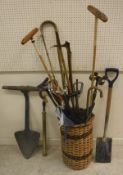 A collection of assorted walking sticks, shooting sticks, two polo mallets,