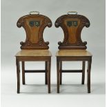 A pair of Regency mahogany hall chairs,