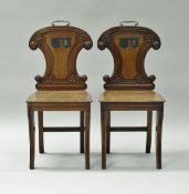 A pair of Regency mahogany hall chairs,