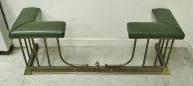 An early 20th Century brass framed telescopic club fender with green leatherette upholstered end