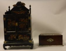 A Japanese lacquered table top jewellery cabinet decorated with Mount Fuji over two cupboard doors