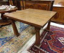 A circa 1900 oak extending dining table on inverted square tapered legs