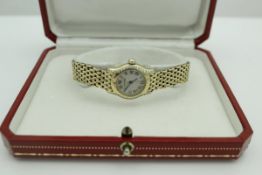 A Cartier ladies 18 carat gold and diamond studded wristwatch,