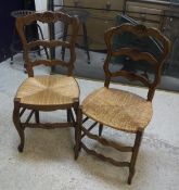 A set of six French oak rush seat ladder back dining chairs