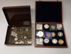 A boxed collection of various modern day commemorative coins including Charles Darwin one dollar,