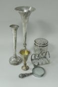 A collection of silver ware comprising two loaded stem vases,