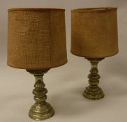 A pair of turned brass candlesticks converted to table lamps in the 18th Century Continental style