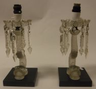 A pair of frosted glass "Dolphin" table lamps on black marble bases in the manner of Lalique