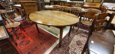 A 19th Century French walnut oval drop-leaf dining table