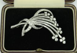 An unmarked white gold and diamond set brooch in the mid 20th Century manner as a floral spray, 6.