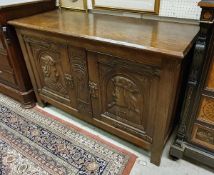 An early to mid-20th Century oak side cabinet in the Gothic Revival taste