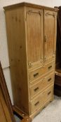 A 20th Century pine two-door cupboard with three drawers