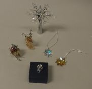 A Swarovski christmas tree topper of snowflake/star form together with two christmas decorations