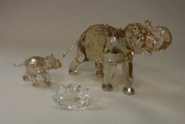 A Swarovski Crystal Society model elephant in coloured crystal "Cinta" together with calf and title