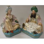 A pair of 19th Century Jacob Petit porcelain dressing table scent bottles as seated Turks,