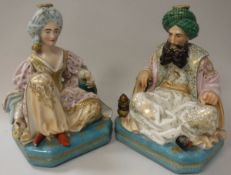 A pair of 19th Century Jacob Petit porcelain dressing table scent bottles as seated Turks,