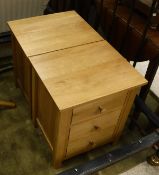 A pair of modern oak three drawer bedside chests