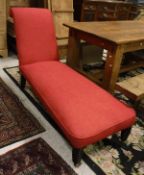 A Victorian upholstered daybed on bobbin turned front supports to casters