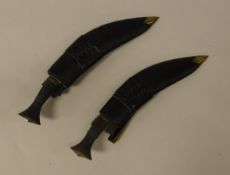 A pair of Gurkha kukris, both with brass mounted horn handles, the blades stamped "16",