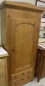 A 19th Century Continental pine wardrobe with single door enclosing a hanging space and small