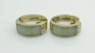 A pair of 14 carat gold earrings of hooped design with central jade panels,