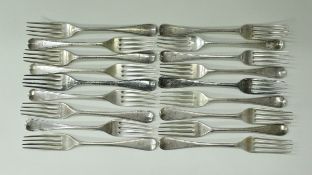 A set of twelve William IV feather edged silver dessert forks (by Richard Britton, London 1831),