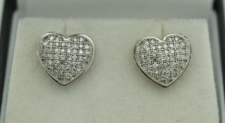 A pair of 9ct gold pave set diamond heart shaped ear studs