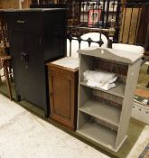 A mid 20th Century ebonised cabinet with single drawer over two cupboard doors enclosing shelves